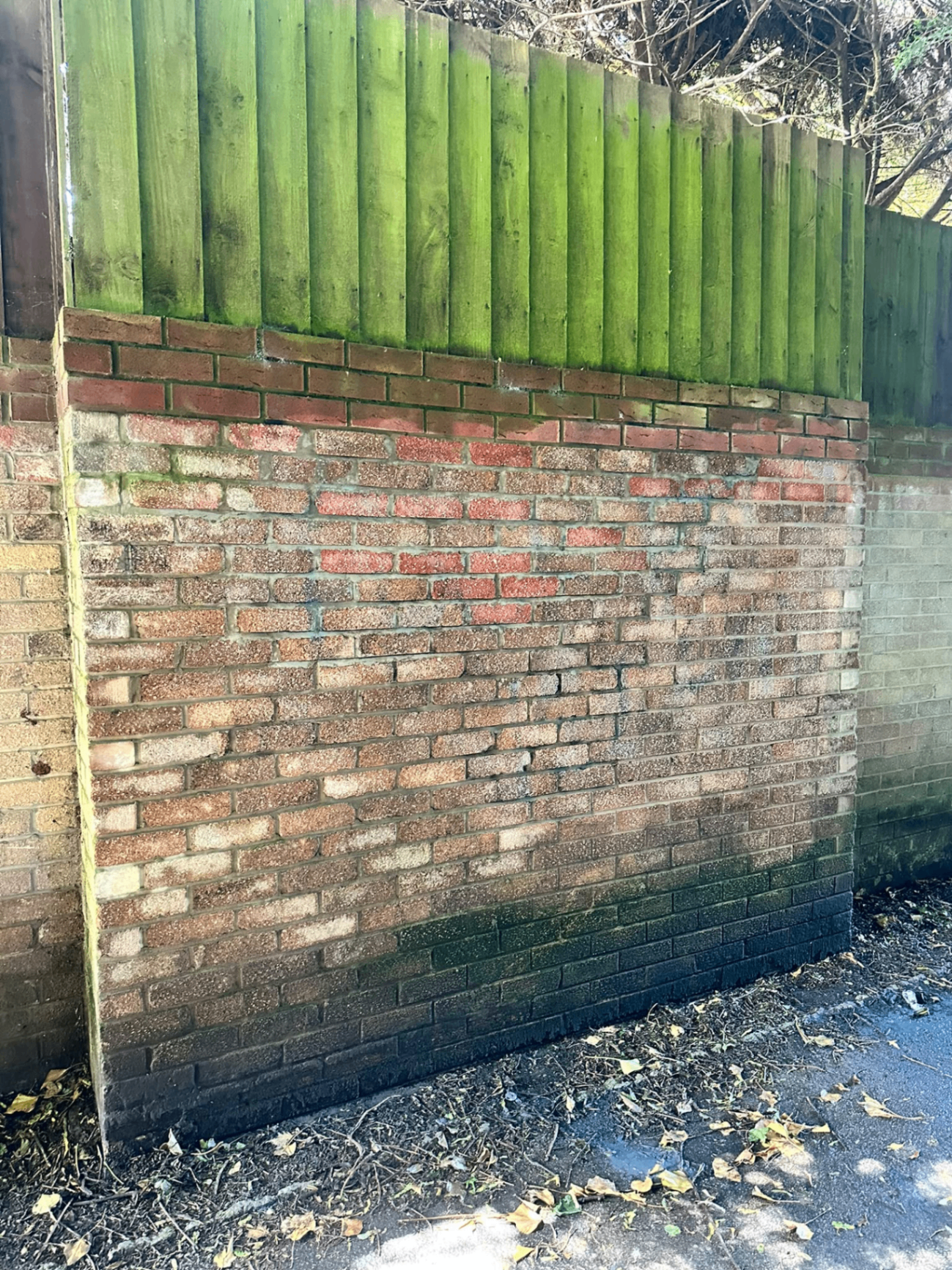 The same brick wall fully restored after professional graffiti removal