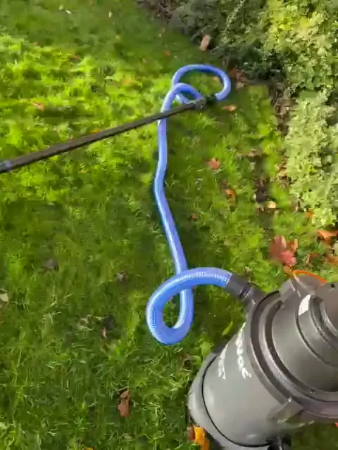 Gutter vacuum removing leaves and debris