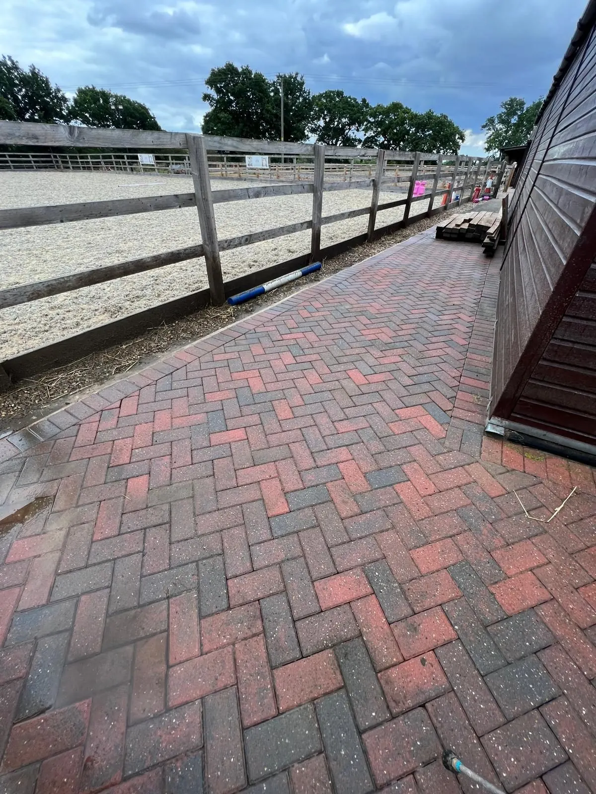 Clean block paving yard at equestrian stables after professional pressure washing