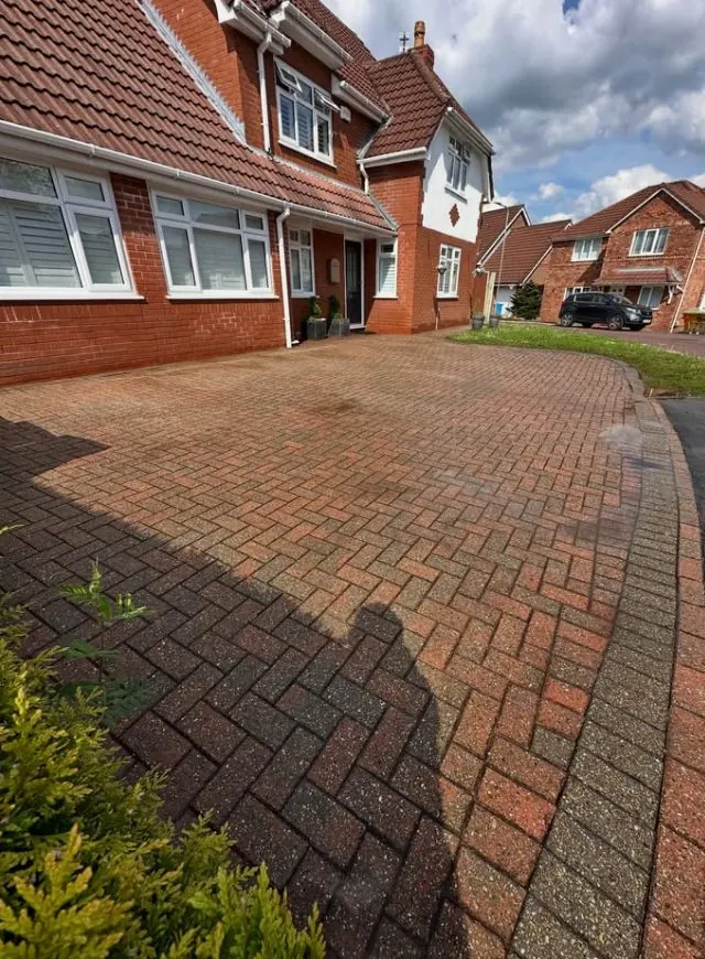 Restored block paving driveway showing vibrant colour after professional pressure washing