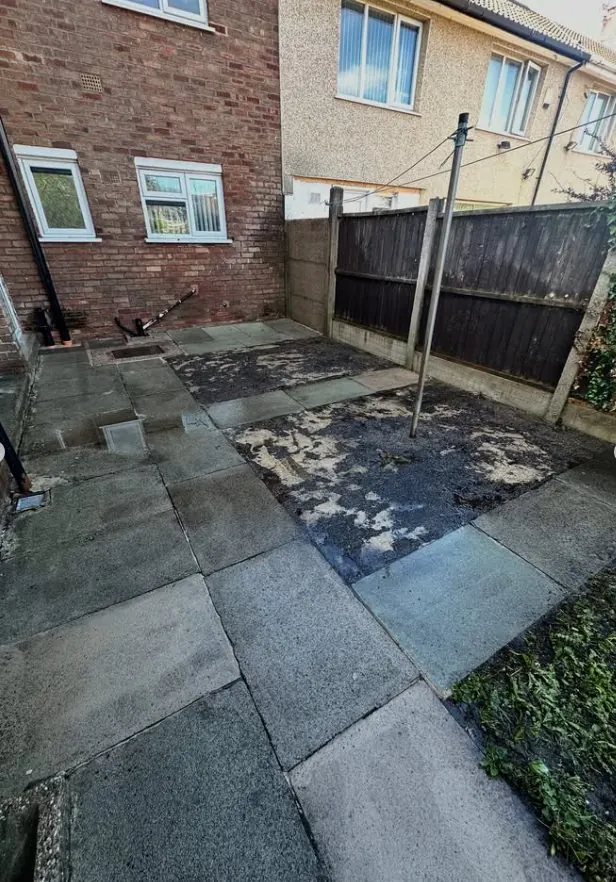 Clean paving slab yard cleared of weeds and debris after professional pressure washing