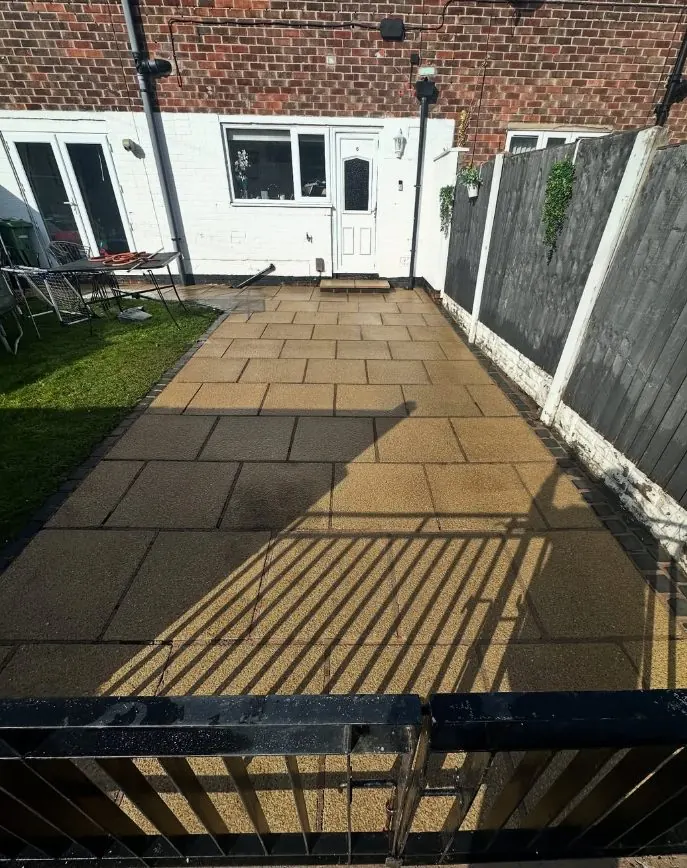 Patio paving stones restored to original golden colour after steam washing
